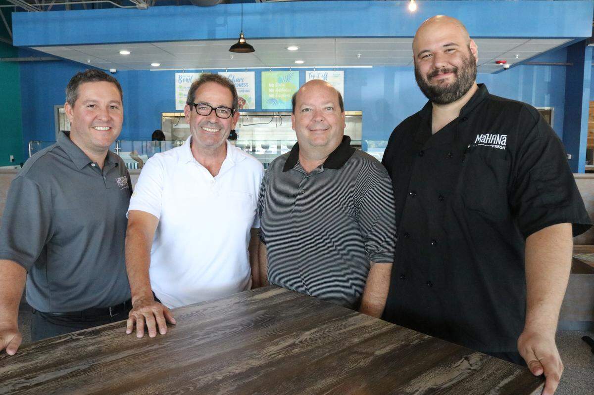 Gathered at the Bradenton Mahana Fresh restaurant this week were, from left, Brad Robinson, John Thomas, Dave Wood, and Mike Kosmowski. Robinson and Kosmowski are franchise owners. Wood and Thomas are founders of the company.