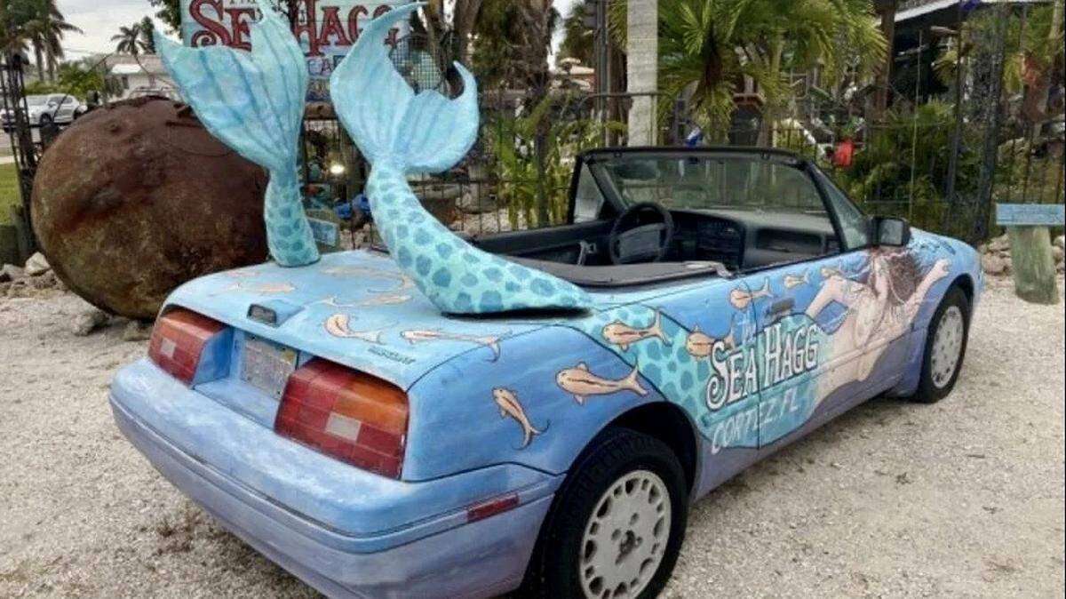 The Sea Hag’s auction items including the 1991 Mercury Capri convertible with twin mermaid tails that served as a landmark for the store.