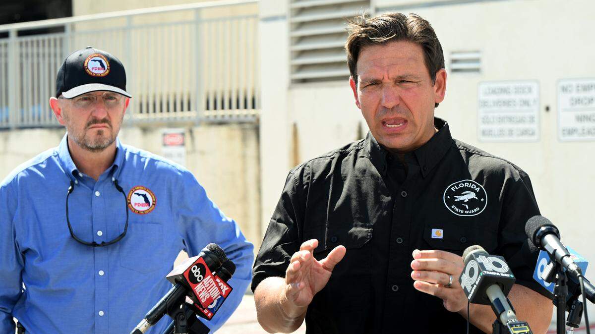 Florida Gov. Ron DeSantis, right, with FDEM Dir. Kevin Guthrie, left, spoke at a press conference at Manatee Memorial Hospital in Manatee County on Monday, Sept. 30, 2024. Florida Division of Emergency Management deployed a Tiger Dam around sections of the hospital before the arrival of Hurricane Helene.