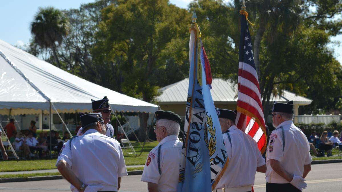 Veterans prepare for a presentation of colors to commence the Veterans Day honors and festivities in Palmetto on Sunday.