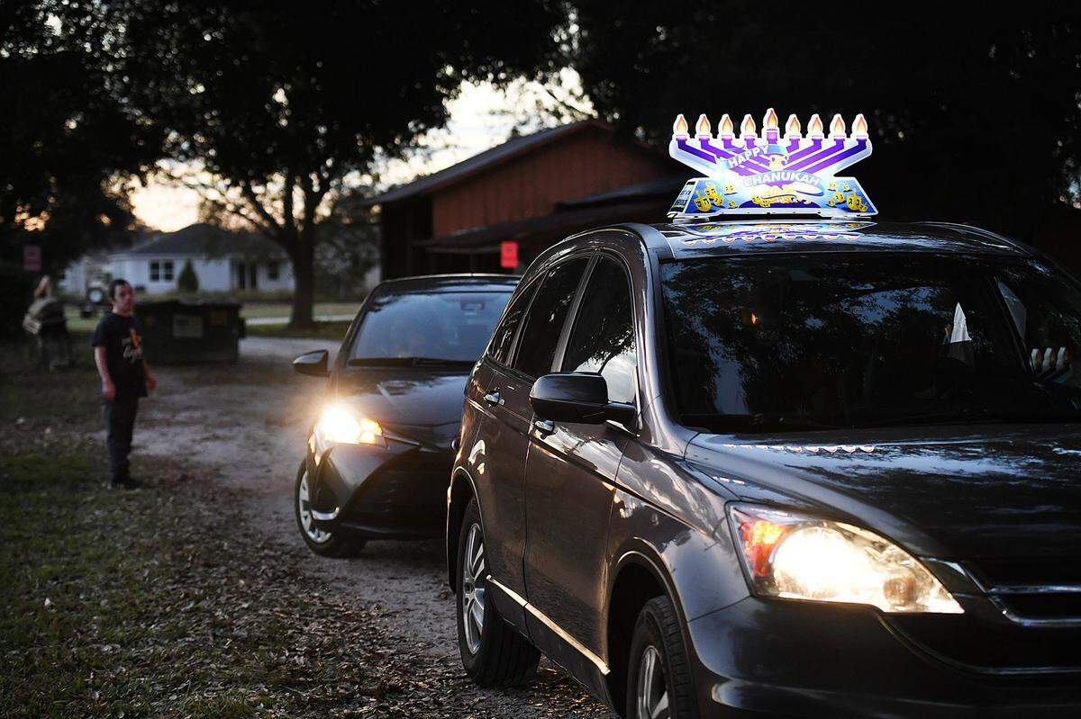 12/01/21—Members of the Chabad of Bradenton meet to install lit menorahs on their cars as they celebrated the 4th night of Hanukkah.