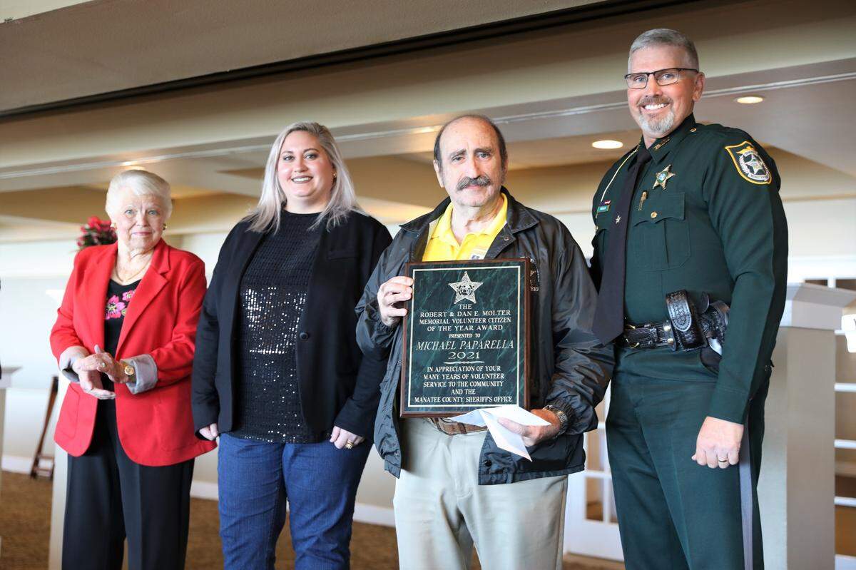 Faith and Mallory Molter with Michael Paparella, the winner of the Robert & Dan E. Molter Memorial Humanitarian Award with Manatee County Sheriff Rick Wells.