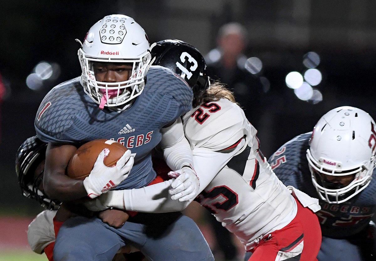 LaJohntay Wester fights off Port Charlotte’s Keegan Rasnick at the Palmetto High playoff football game in Class 6A-Region 3 Friday night.