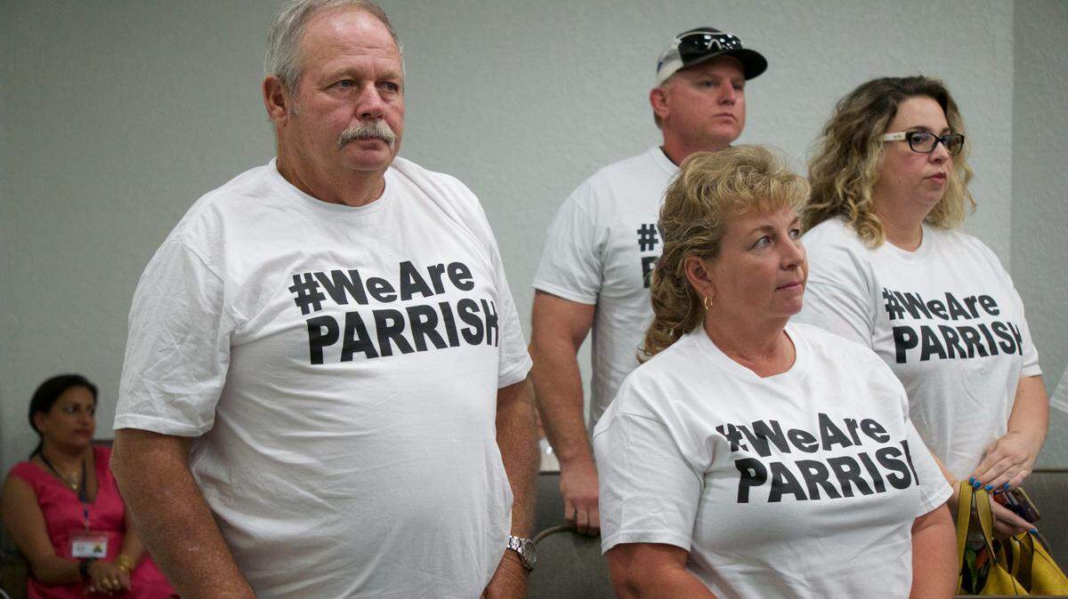 At a July 24 school board meeting, Parrish residents stand in support of their community and the renaming of North River High School to some form of Parrish High School.