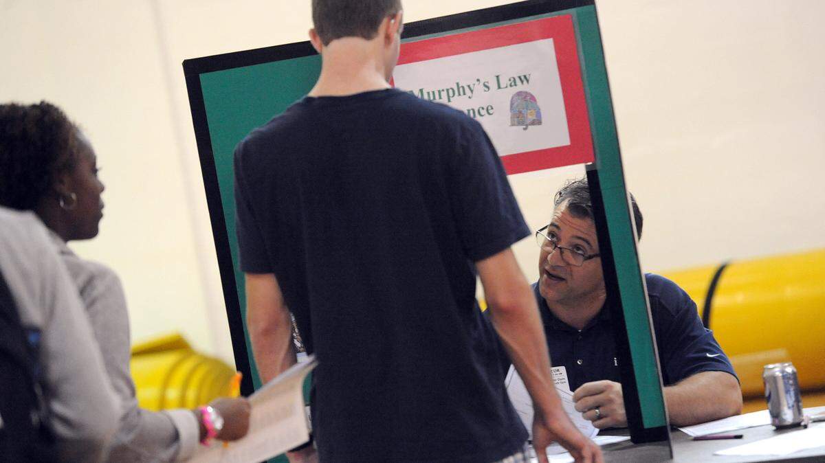 Manatee High students speak with Christopher Dorn at the school's "Big Bank Theory," which teaches students how to manage money in an exercise designed to simulate the real-life experiences of budgeting and spending money on necessities. 
 TIFFANY TOMPKINS-CONDIE/Bradenton Herald