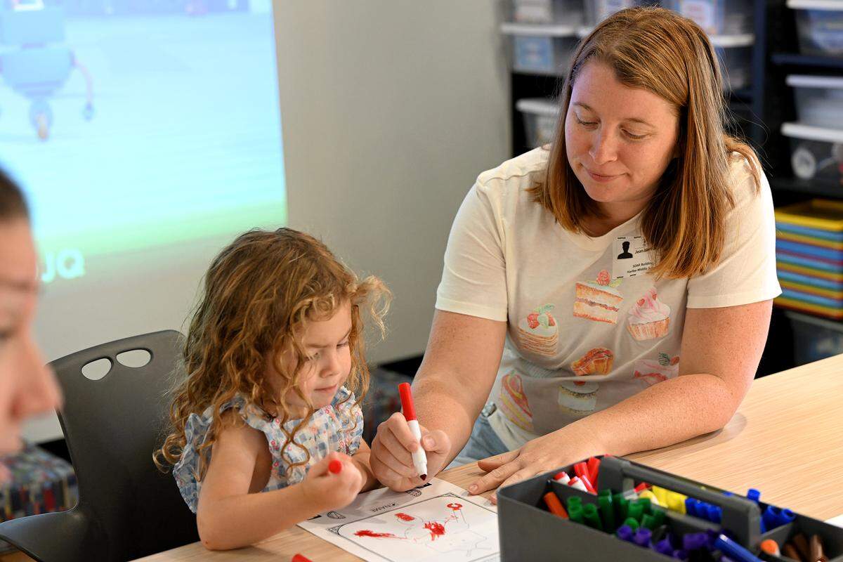 Jean Heredia and Carolina color a robot at the Soar Lab, which recently opened in Manatee County's Sara Scott Harllee Center. The lab provides families with hands-on learning experiences that are tied to early development learning standards shown on Friday, Oct. 17, 2025.