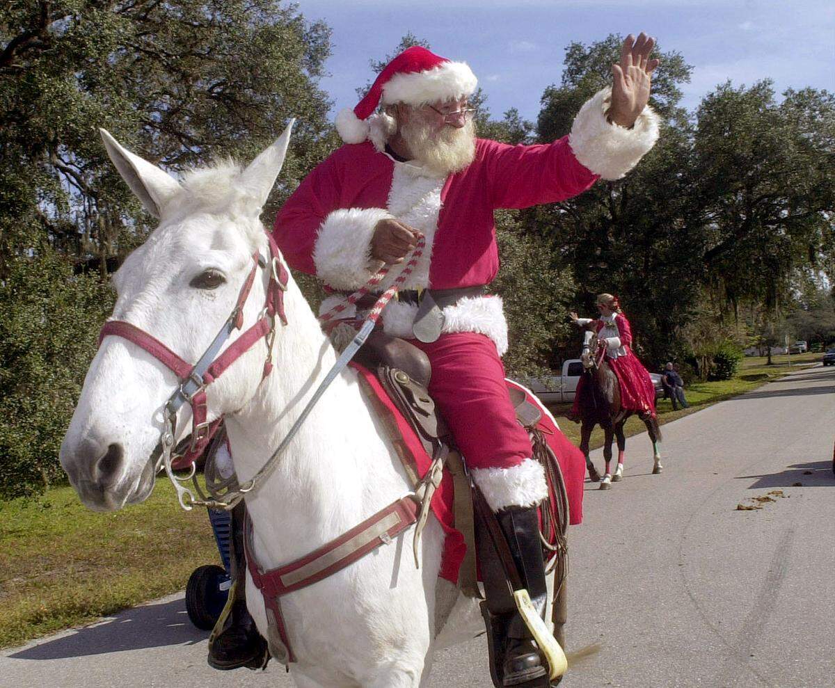 Doug Jones as Santa waves to the folks who lined up along the streets in Myakka City Saturday to watch the 4th annual Christmas Parade, 2000.