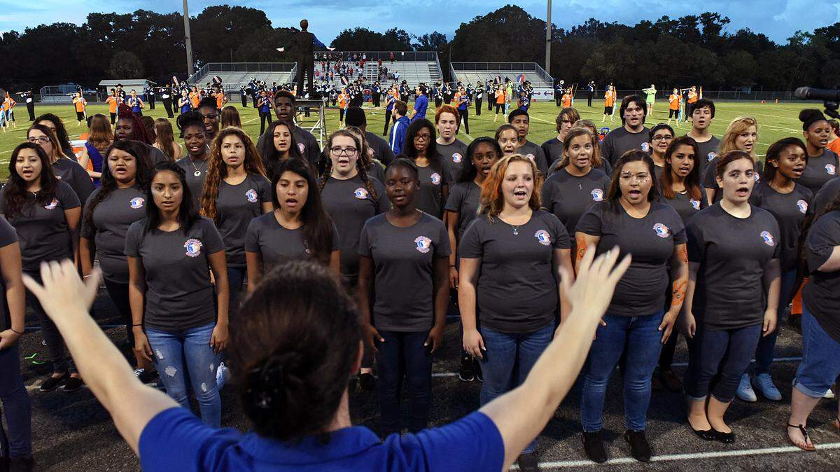 Southeast's chorus sings the national anthem before Friday night's homecoming game against Cardinal Mooney, next week they are getting a new grand piano. 
 TIFFANY TOMPKINS-CONDIE/Bradenton Herald