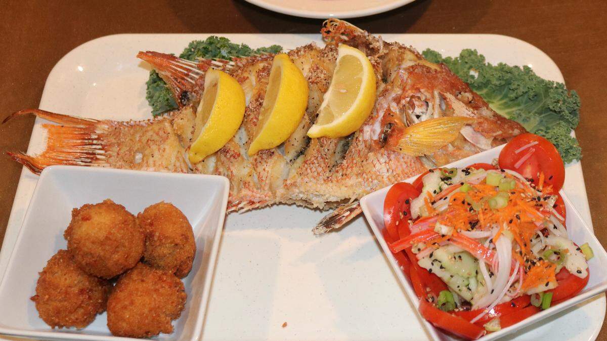 7/12/2021--The Clam House Bar and Grill, 304 7th St. W., Palmetto, recently reopened after closing in January. The Thai Fry, shown above with salad and hush puppies, the most popular item on the menu, is back.