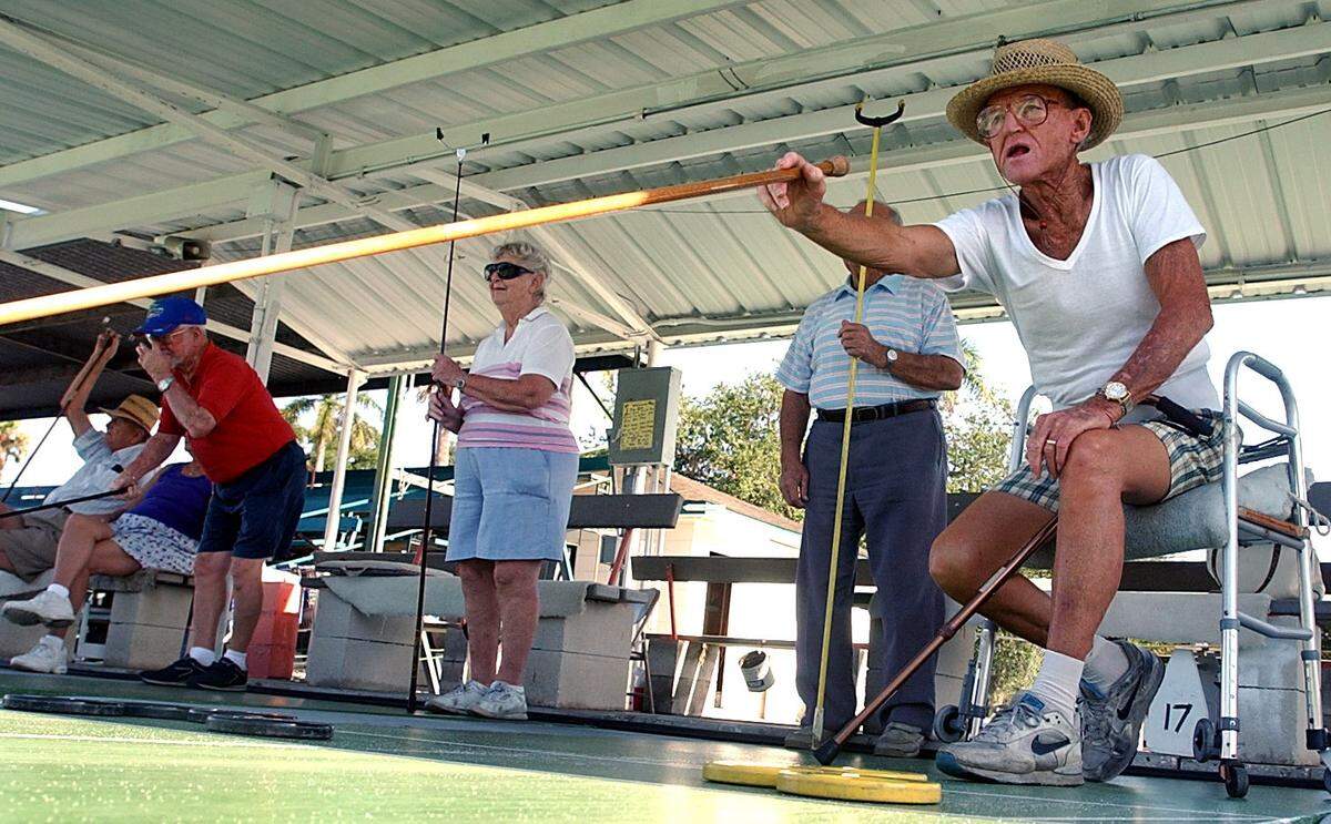 Bradenton Shuffleboard Club member and Florida Hall of Famer Russ DeHart takes his turn at play in a tournament in 2004.