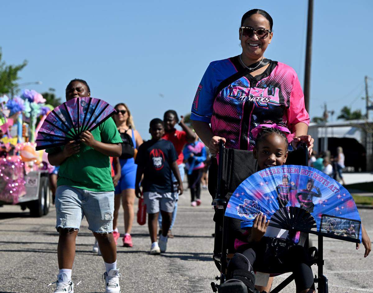 A young dancer with a foot injury still manages to perform with a fan at the annual DeSoto Children’s Parade and Party in the Park in Palmetto on April 18, 2025.