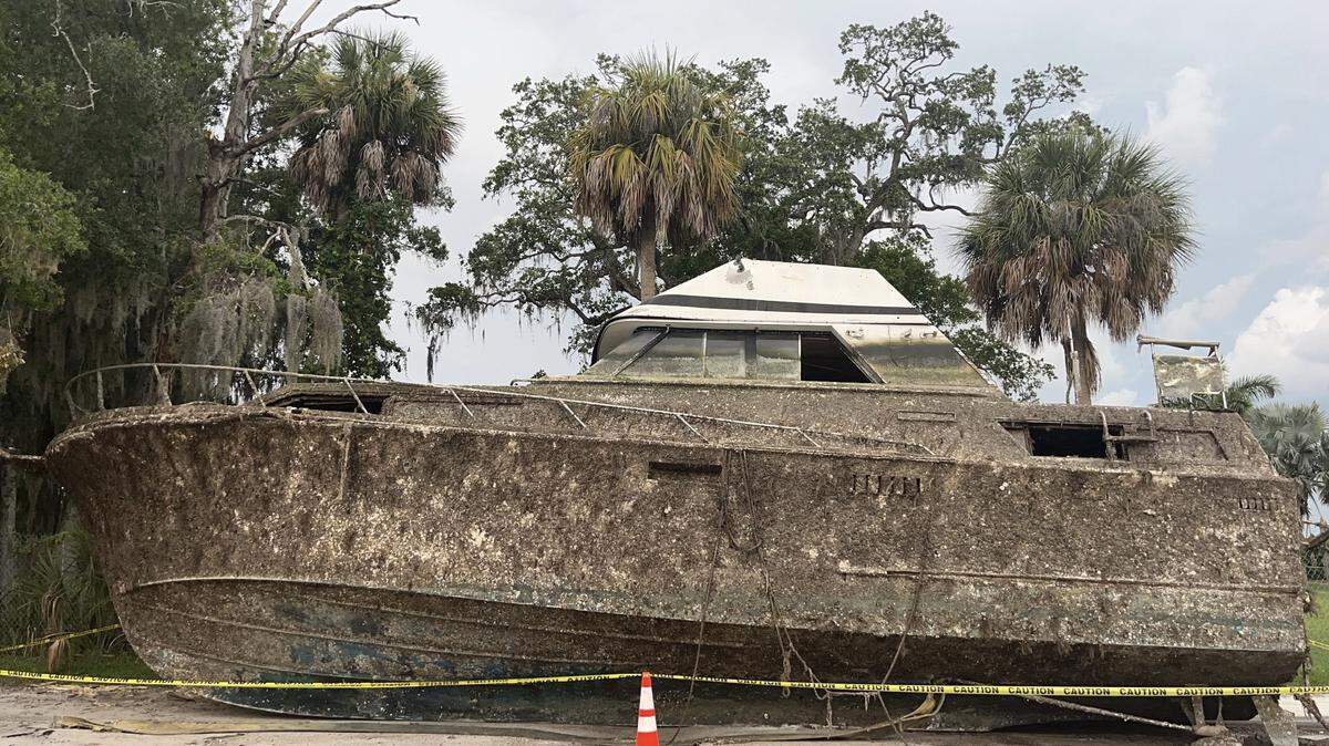Florida Fish and Wildlife Conservation Commission removed a derelict boat from the Manatee River, before being transported away the boat was parked in a lot across from the Green Bridge fishing pier.