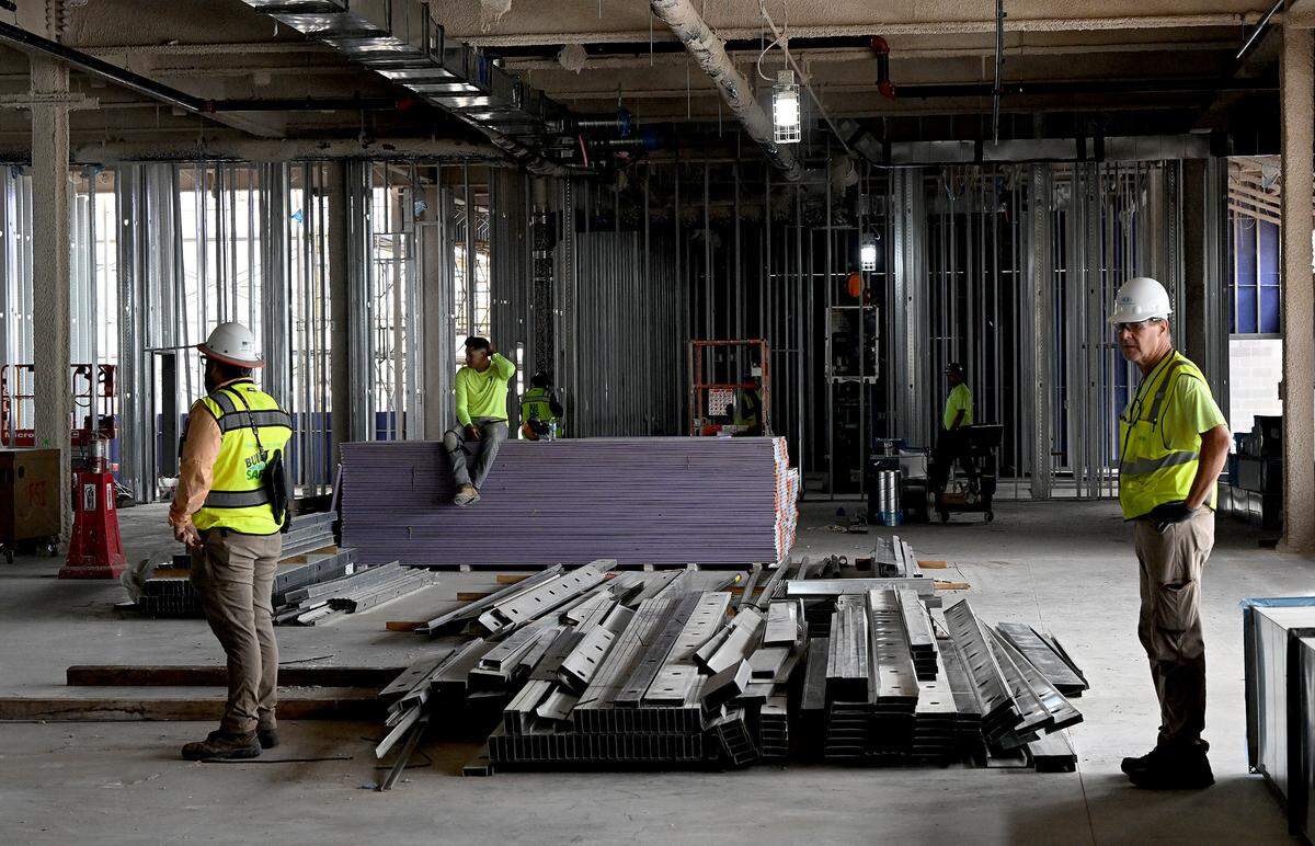 Construction workers paused as House Speaker Mike Johnson, R-LA, toured the construction site for the $100 million ground-level passenger terminal at Sarasota Bradenton International Airport.