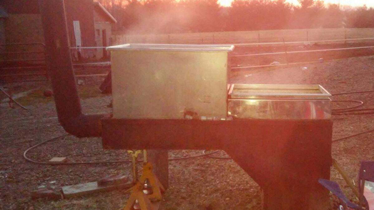 Lovina Eicher’s sons-in-law Tim and Mose have cooked many gallons of sap into maple syrup this spring.