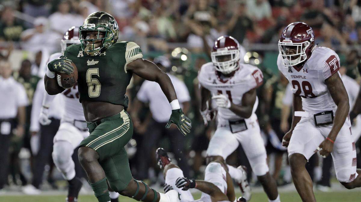 South Florida running back Darius Tice (6) outruns the Temple defense, including defensive back Jyquis Thomas (28) on a 47-yard touchdown run during the first half of an NCAA college football game Thursday, Sept. 21, 2017, in Tampa, Fla.