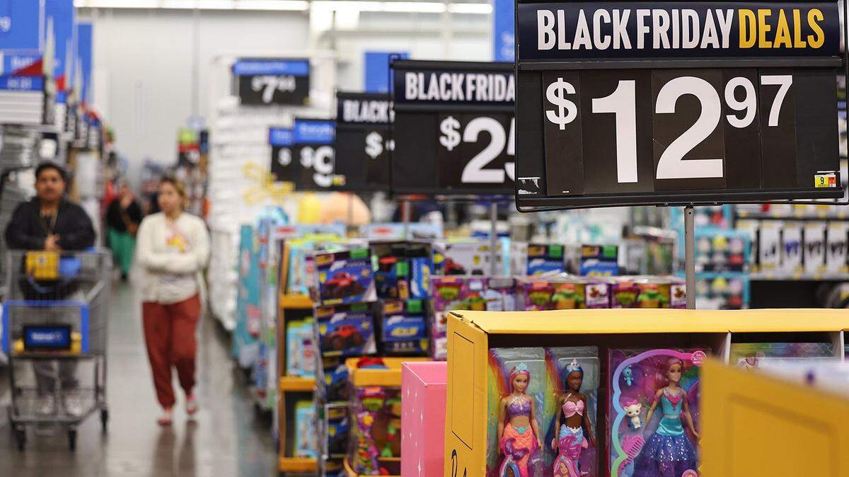 Barbie dolls (right) are displayed for sale ahead of Black Friday at a Walmart Supercenter on Nov. 14, 2023, in Burbank, California. Some early Black Friday deals are already in place at Walmart and other retailers ahead of Thanksgiving and the traditional holiday shopping season.