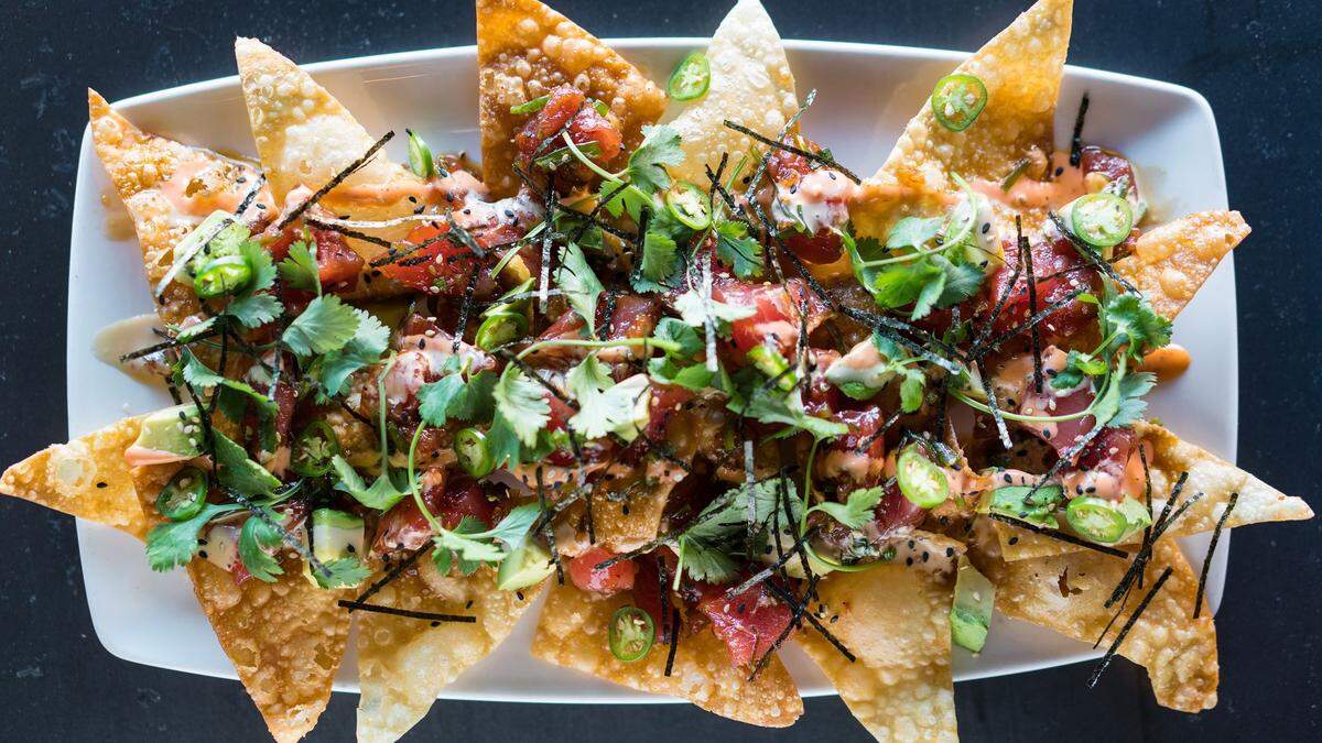 Yard House, known for having more than 100 beers on tap,&nbsp; along with craft cocktails, tacos, burgers, seafood and steaks, served with a helping of rock music, opened Sunday at University Town Center. Shown above is the Yard House Poke Nachos.