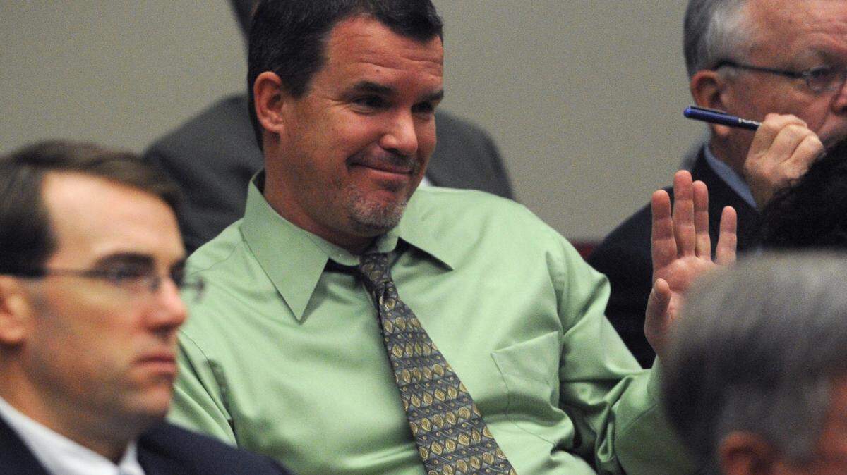 Charlie Kennedy, Manatee County School Board, waves as he is acknowledged by Manatee County commissioners as they consider a vote to support a recommendation by the school board to reinstate impact fees to pay for schools. 
 GRANT JEFFERIES/Bradenton Herald