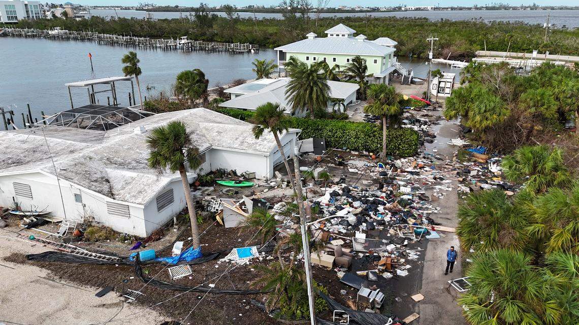 Damage and debris in front of homes in Charlotte County near Manasota Key on Thursday, Oct. 10, 2024, the morning after Hurricane Milton hit the area and two weeks after Hurricane Helene struck the area.