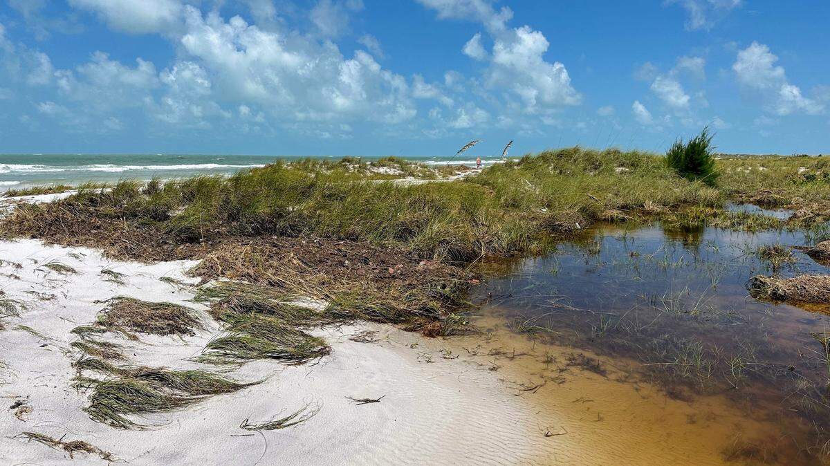Hurricane Idalia’s storm surge flattened the sand dunes on Anna Maria Island. As of Thursday afternoon, standing water remained near a beach access point at Bean Point.