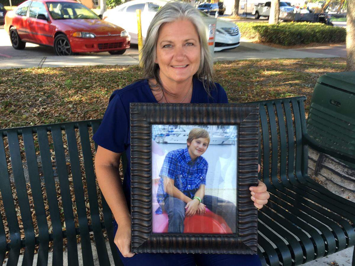 Parrish's Gretchen Fowler holds a portrait of her son, Anthony. Anthony died at age 11 after part of a hill of dirt caved in on him while the family was living temporarily in California in 2012. Anthony became an organ donor and his organs saved five lives. Gretchen Fowler and her husband, Freddie, will raise the National Donate Life Day flag at Blake Medical Center on Friday, April 21.