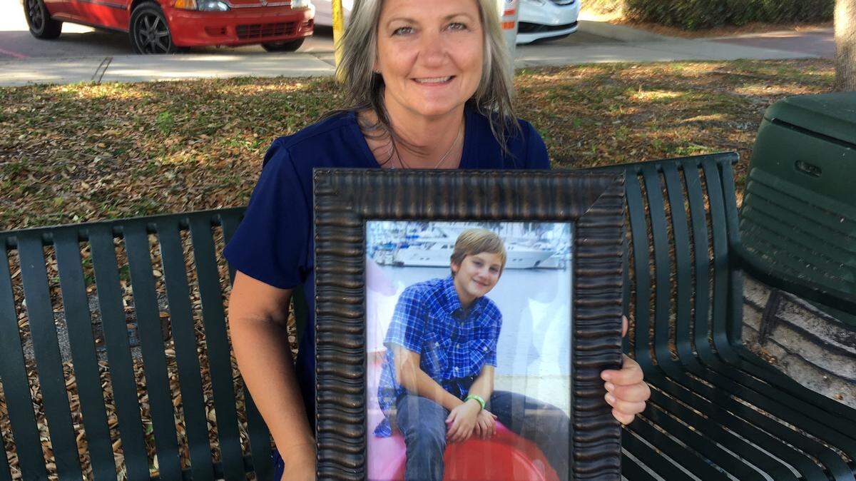 Parrish's Gretchen Fowler holds a portrait of her son, Anthony. Anthony died at age 11 after part of a hill of dirt caved in on him while the family was living temporarily in California in 2012. Anthony became an organ donor and his organs saved five lives. Gretchen Fowler and her husband, Freddie, will raise the National Donate Life Day flag at Blake Medical Center on Friday, April 21.