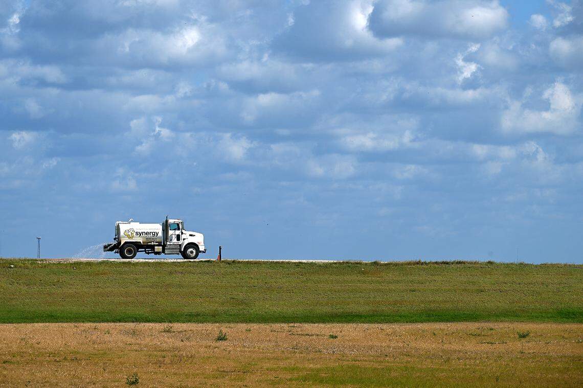 Site operators at Piney Point recently announced a milestone achievement with the closure of the Old Gypsum Stack-South compartment, one of four ponds that need to be closed at the former phosphate processing plant. A water truck sprays the encircling dirt road atop the stack.