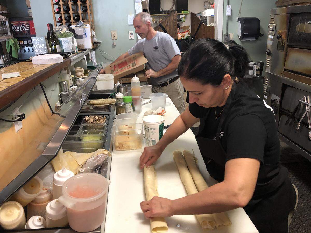 Maria Favasuli makes homemade manicotti, while her brother, Mike Favasuli, finishes a pizza order at Fav’s Italian Cucina. The restaurant opened at 20 years ago at 419 12th St. W. in downtown Bradenton.