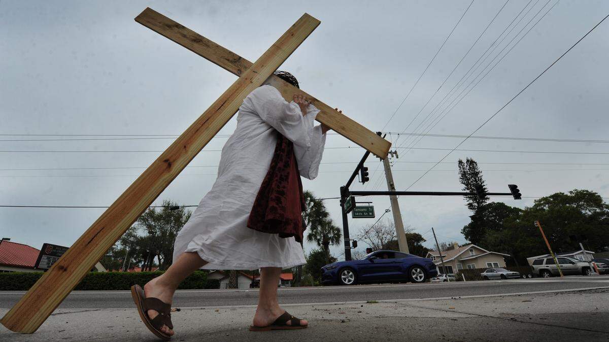 Carrying a message of love on Good FridayA man, who wished to remain nameless, carries a wooden cross Friday along 14th Street West in Bradenton. The message he wishes to convey is, "I love you." The Christian holiday of Good Friday remembers the crucifixion and death of Jesus Christ on Calvary, leading up to Easter Sunday celebrating Christ's resurrection. GRANT JEFFERIES/Bradenton Herald