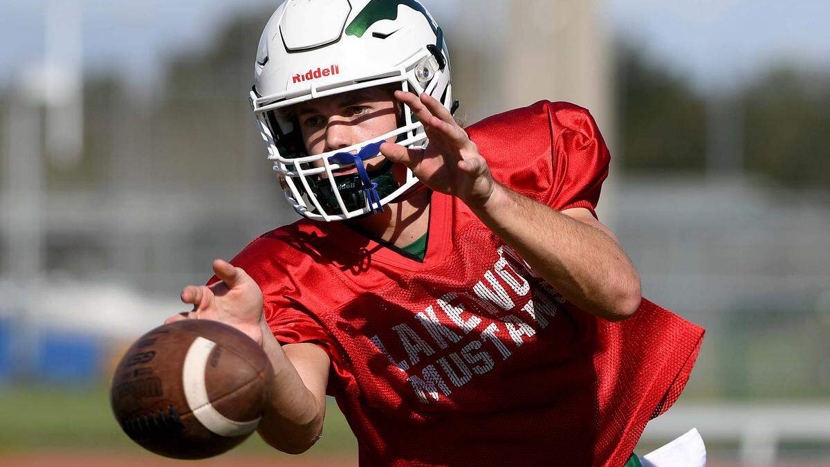 Clayton Dees reaches out to catch a pass at Lakewood Ranch High football practice at the stadium field Monday afternoon.