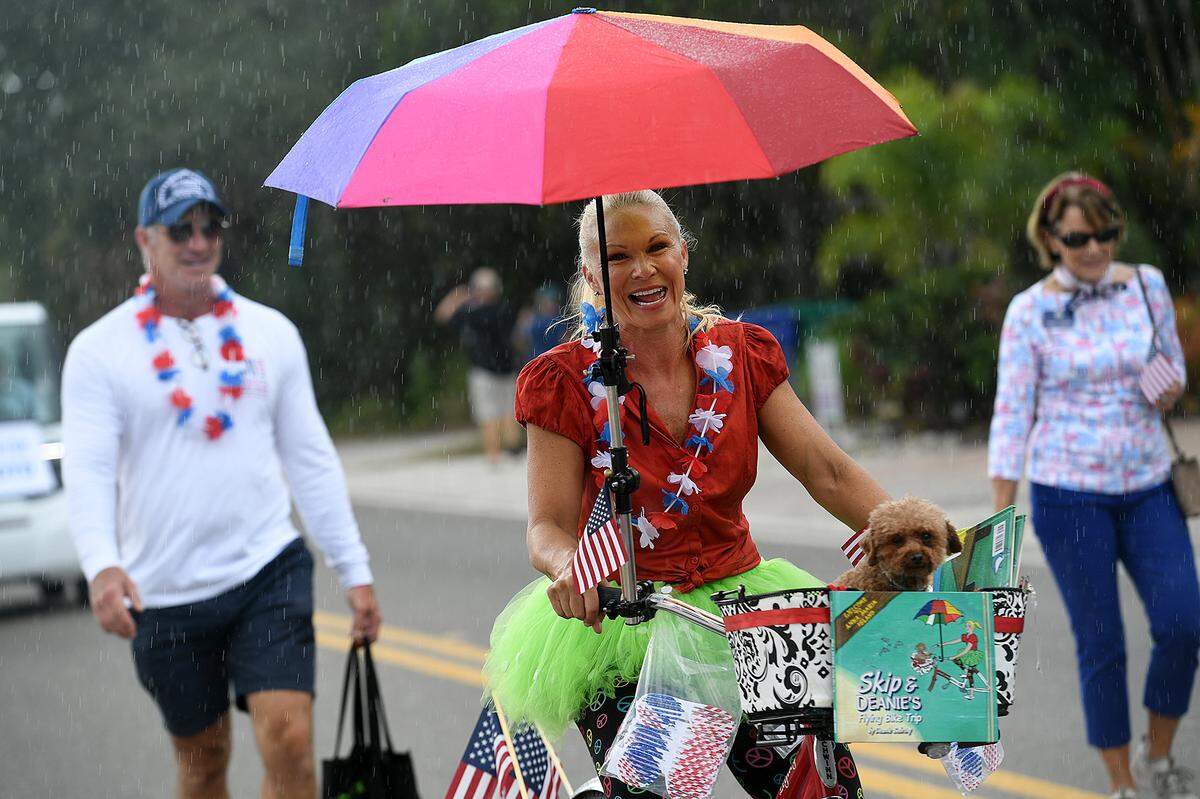 11/11/21—City Commissioner Deanie Sevring and her dog, Humphrey, don’t mind the rain in the City of Anna Maria’s Old Soldiers and Sailors Veterans Day Parade.