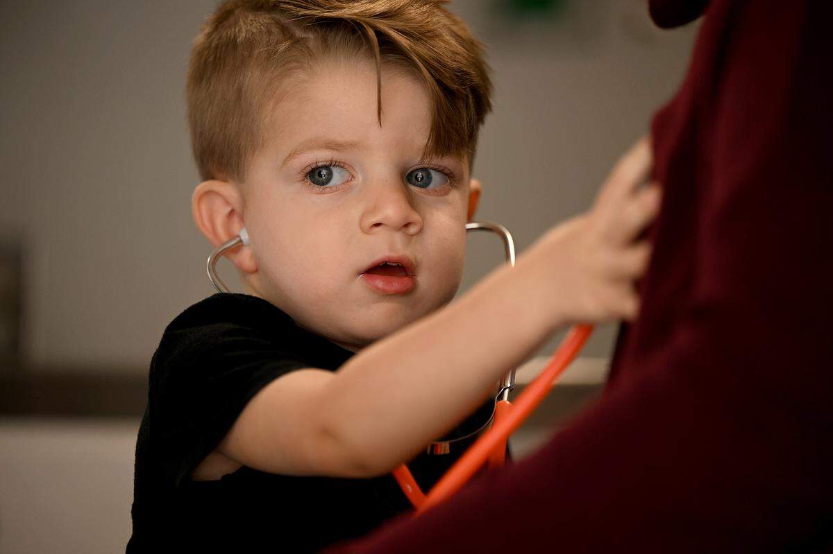 Nolan Backus, 2 1/2, uses a stethoscope in the back of an ambulance at EMS Station 10. Backus got to meet the Manatee County charge paramedic Kevin Guido, 36, who treated him in an ambulance after he suffered a seizure at his daycare in March.