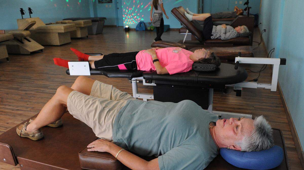 Seniors work out on a toning tables at Tone E-Z, a fitness center geared toward senior citizens to help them stretch and move using powered tables. 
 GRANT JEFFERIES/Bradenton Herald