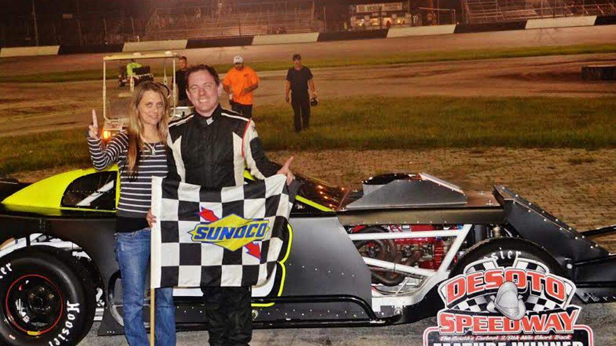 Jesse Dutilly holds up a checkered flag in Victory Lane after winning the Open Wheel Modified race Saturday at Desoto Speedway. PROVIDED PHOTO