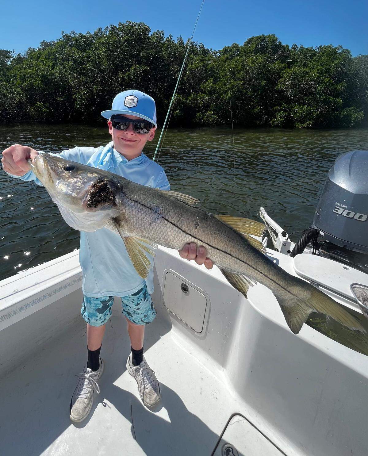 Keller Nelson, 10, poses with a snook he recently caught fishing in Miguey Bay off of Terra Ceia with Palmetto-based Captain Griffin Deans.