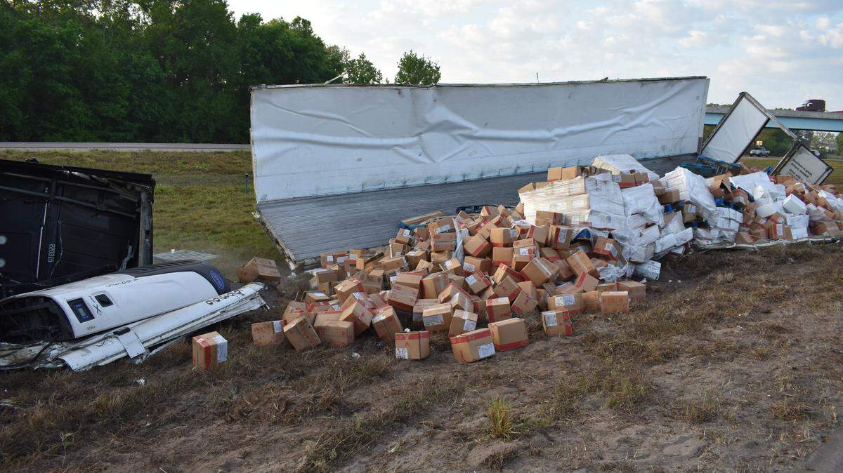 A tractor-trailer tipped and spilled hundreds of boxes of frozen food in a three-vehicle crash on Interstate 75 in Manatee County on Tuesday morning, Florida Highway Patrol said.
