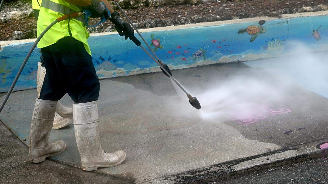 City of Bradenton employees were busy pressure washing the art from the sidewalks on 12th Avenue West in the Village of the Arts on Wednesday, Aug. 27, 2025. The city said in a release that it is “fully complying with FDOT’s order and is working to complete the required removals by the September 4 deadline.”