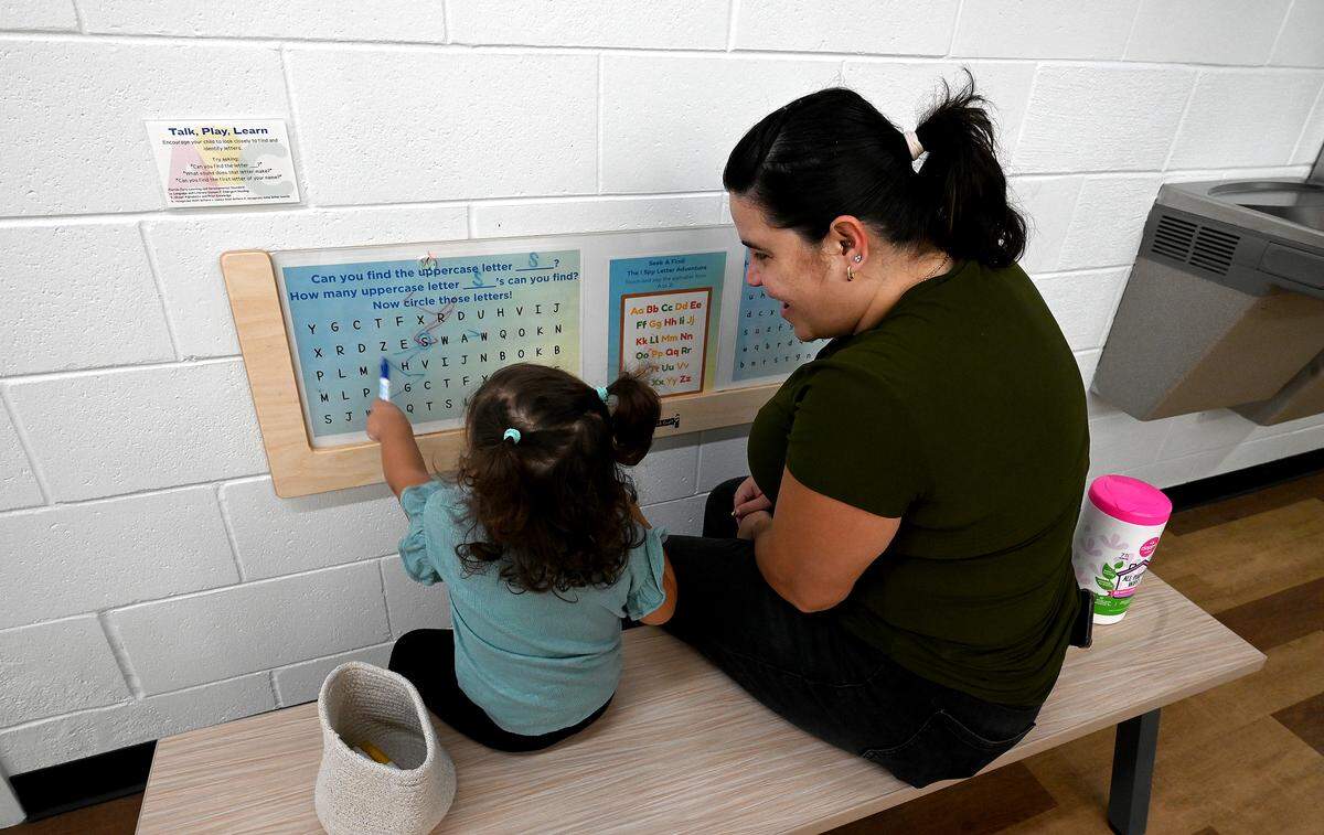 Dalisse Colon Sanchez, right, with Aurora, 2, as she explores letters at the Soar Lab, which recently opened in Manatee County's Sara Scott Harllee Center. They provide families with hands-on learning experiences that are tied to early development learning standards shown on Friday, Oct. 17, 2025.