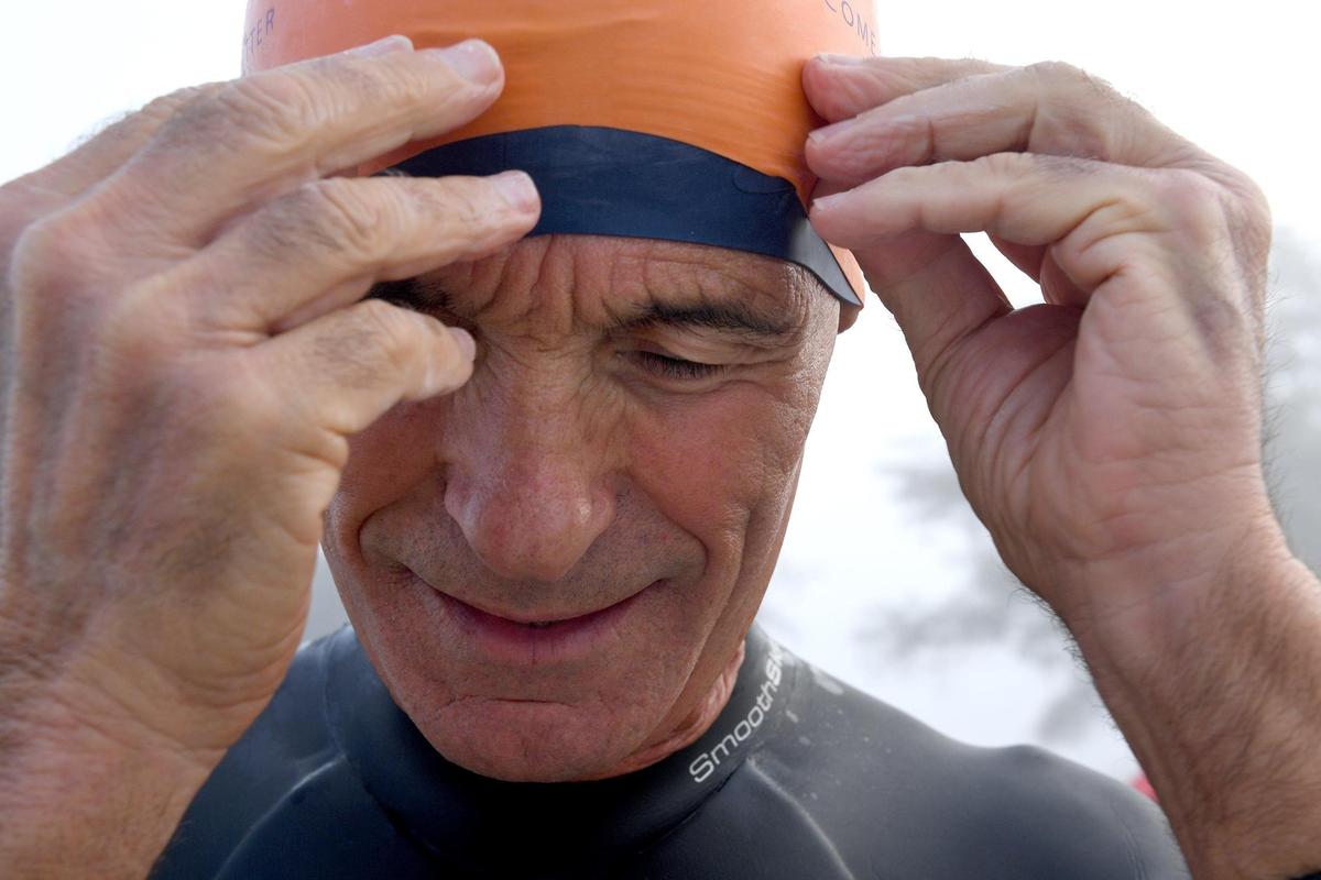 Victor Sultana puts his swim cap on to prepare for the morning’s swim. The AMI Swim Club, also known as the Hogfish, had to find alternate swim locations when red tide was present in the waters of Manatee Public Beach. Now they’re back in their home waters.