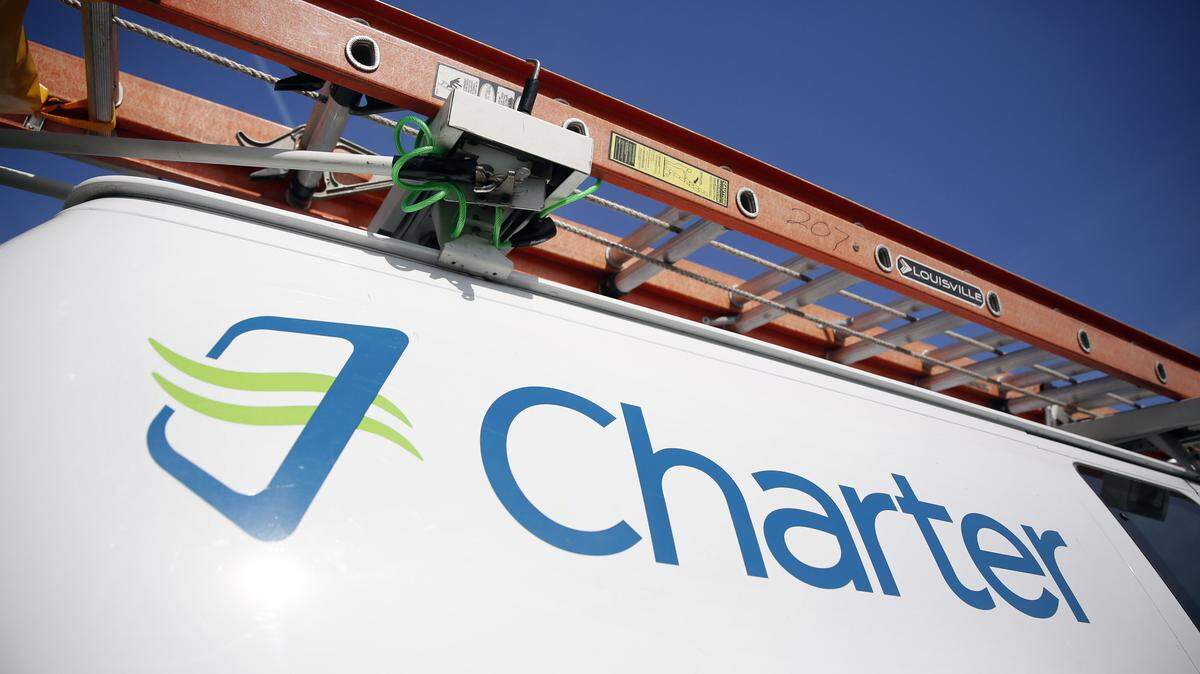 FILE - This April 1, 2015, file photo, shows a Charter Communications van in St. Louis. On Monday, April 25, 2016, the Justice Department approved Charterís bid to buy Time Warner Cable and create another cable giant. Mondayís OK comes with conditions meant to preserve competition from online services. Additional approvals are required, but expected, before the deal closes. (AP Photo/Jeff Roberson, File)