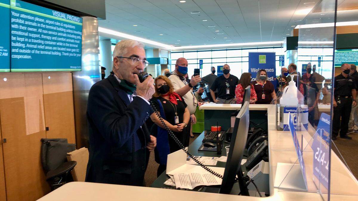 2/14/2021--Rick Piccolo steps behind the counter to speak to the crowd awaiting the arrival of the first Southwest Airlines flight at  Sarasota Bradenton International Airport on Sunday.