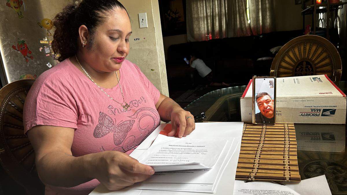 Sheysa Romero Santos sorted through her husband’s immigration paperwork, while the two chatted on FaceTime.