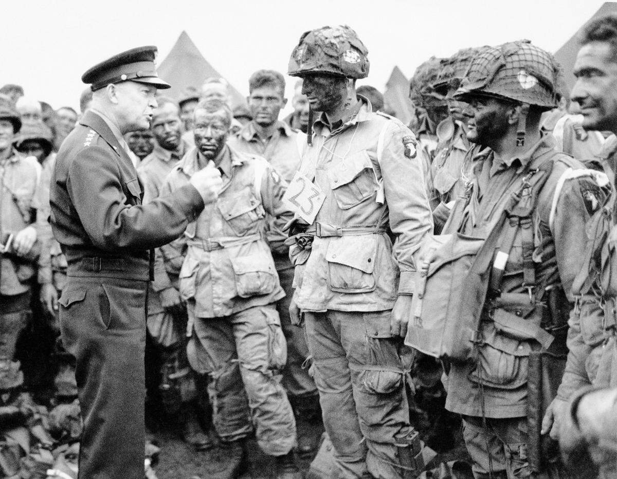 In this June 6, 1944, file photo, U.S. Gen. Dwight D. Eisenhower, left, gives the order of the day to paratroopers in England prior to boarding their planes to participate in the first assault of the Normandy invasion. A dwindling number of D-Day veterans will be on hand in Normandy in June 2019, when international leaders gather to honor them on the invasion’s 75th anniversary. (U.S. Army Signal Corps via AP)