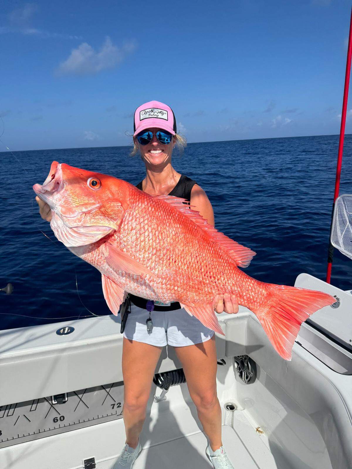 Crystal Davenport poses with a 28-pound red snapper that weighed in as the largest of its kind in the 2025 Suncoast Snapper Slapper tournament.