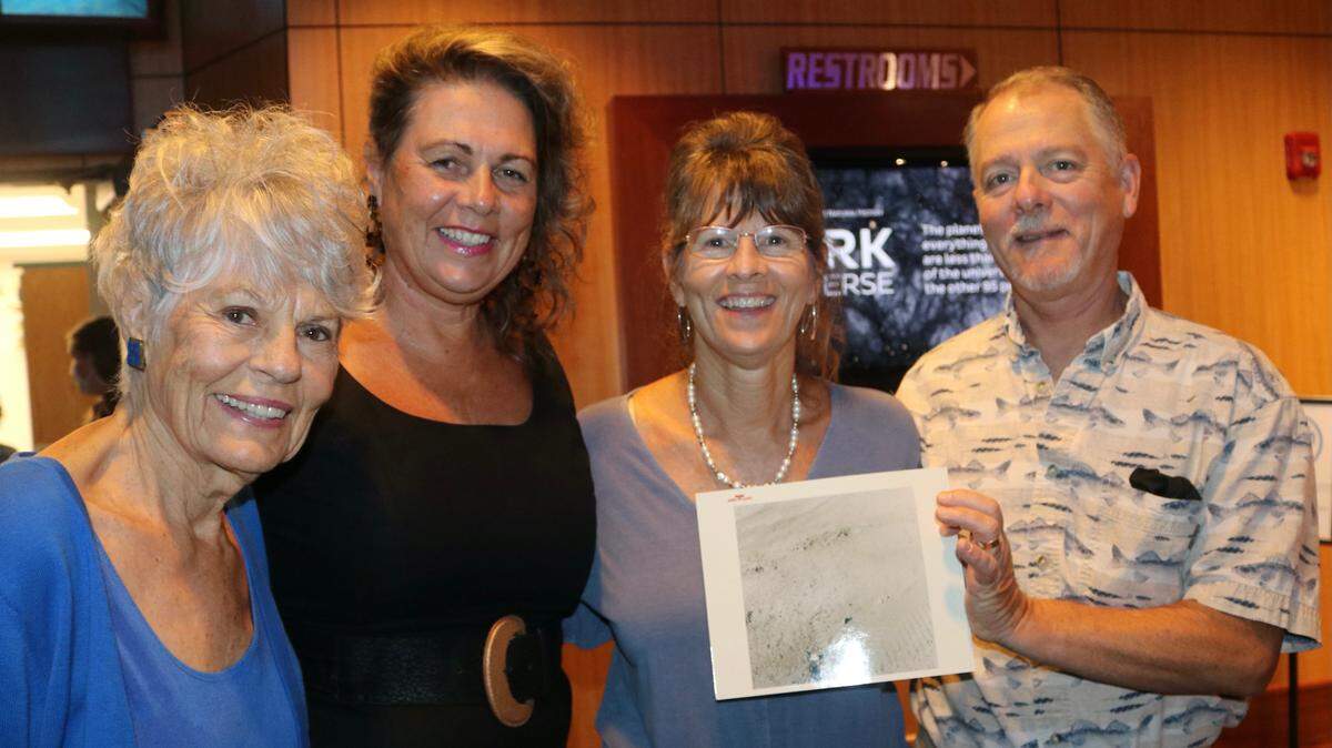 8/4/2021--The family of Apollo 15 astronaut Jim Irwin, the lunar module pilot who also drove the lunar rover in 1971, hold a photo of an astronaut’s foot print on the moon’s surface. Next to the footprint, Jim Irwin left an impression of all their fingerprints. From left are Mary Ellen Irwin-Vickers, Joy Irwin Schtakleff, Jill Irwin Christensen,and Jim Irwin II.