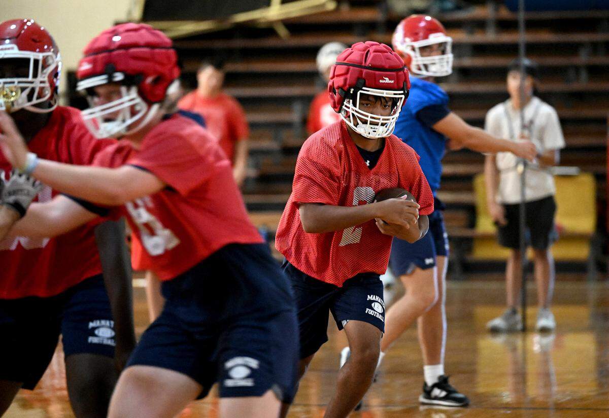 The Manatee Hurricanes High School football team practice indoors in the JROTC gym on the campus as the heat index pushed 94 outside.