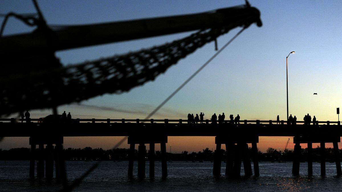 Spectators line the Cortez Bridge on Saturday to watch the 2015 Holiday Lighted Boat Parade. 
 GRANT JEFFERIES/Bradenton Herald