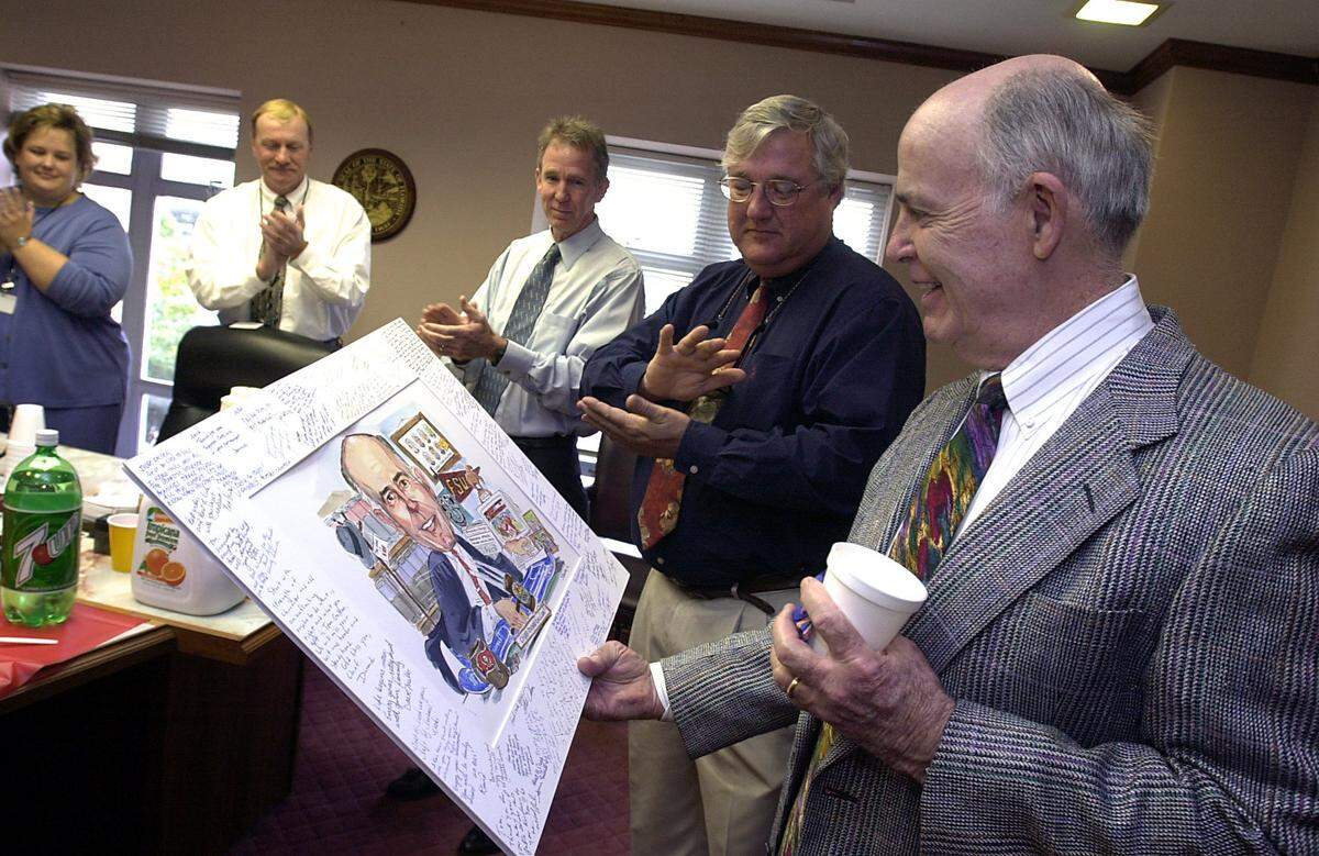 12/31/02--Judge Tom Gallen was presented with a caricature of himself featuring objects which he loves by employees of the Manatee County Courthouse at his retirement party. He recently received the Manatee River Fair Association’s Distinguished Citizen Award.