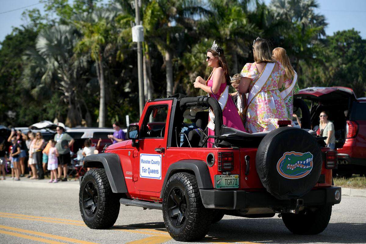 The Manatee County Fair Queens throw beads during the Hernando DeSoto Historical Society’s Children’s Parade on Friday, April 7, 2023 in Palmetto.
