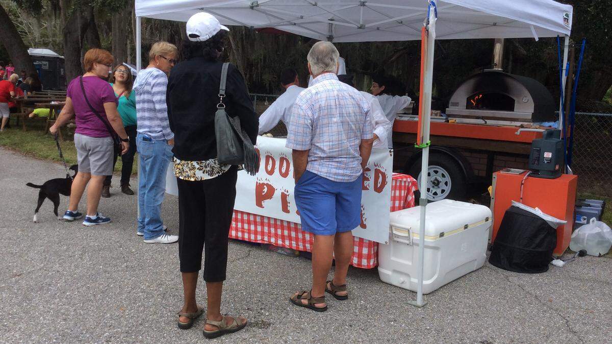 The estimated 3,000 people, many with their dogs, who attended Canine Christmas at Bishop Animal Shelter in Bradenton enjoyed the dozens of vendors at the event. 
 JESSICA DE LEON/Bradenton Herald
